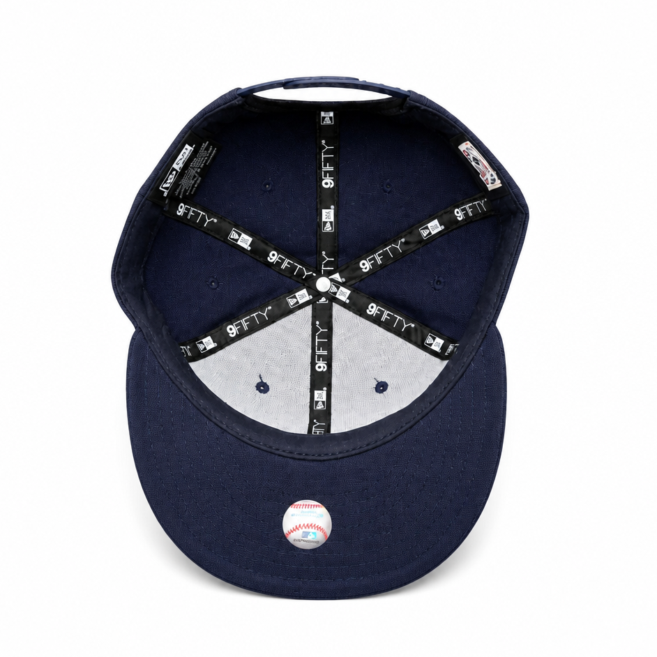 Navy blue baseball cap with a white interior and visible brand logo on a white background