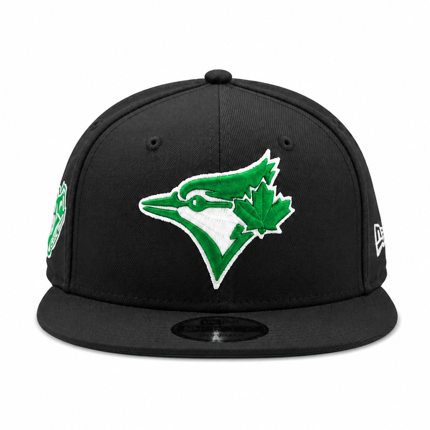 Black baseball cap with green and white logo on a white background