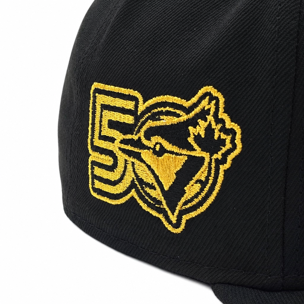 Black cap with a gold embroidered logo on a white background