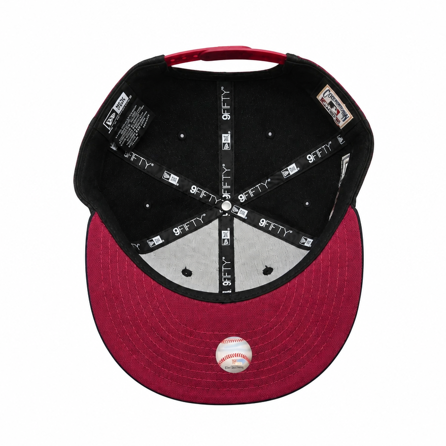 Baseball cap with red brim and black top on a white background