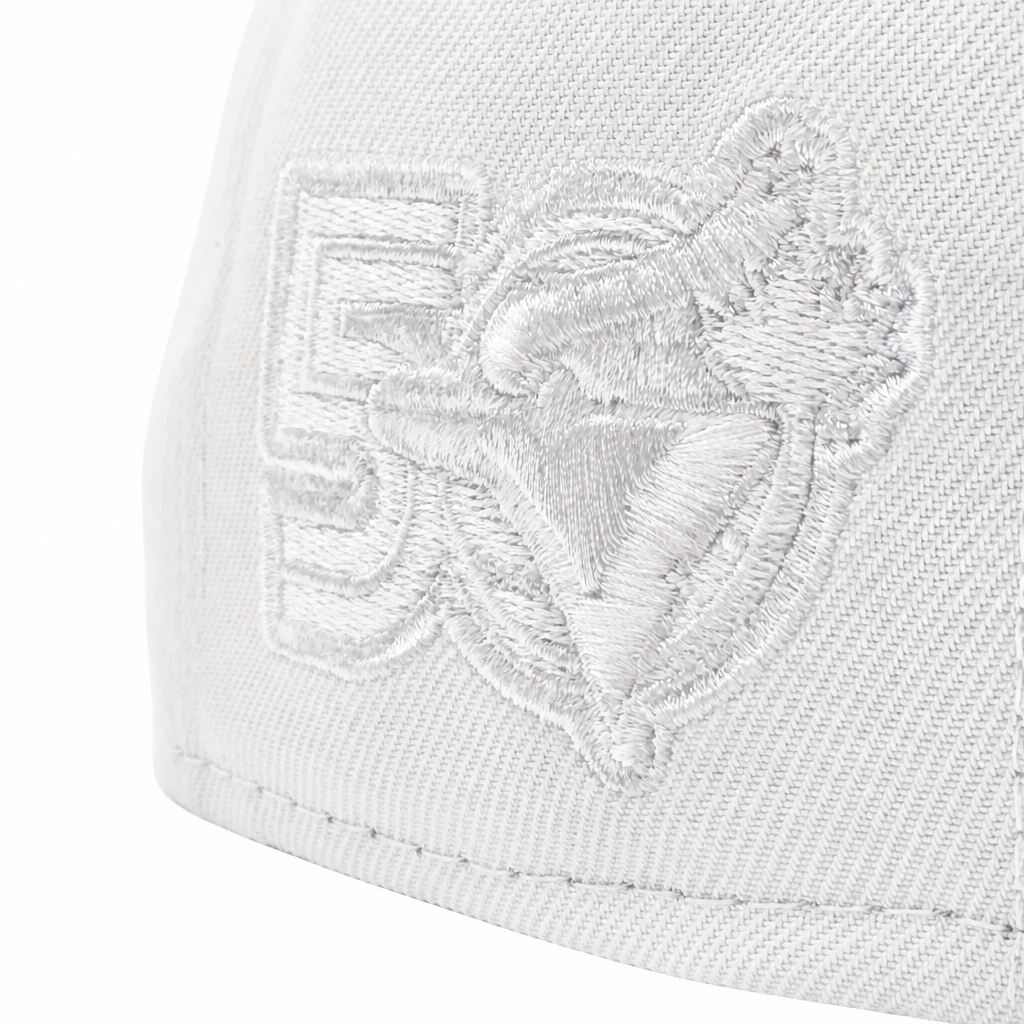 Close-up of a white structured baseball cap featuring an embroidered white-on-white logo of a horse and rider with the number 5.