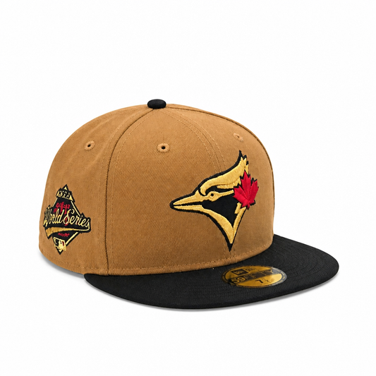 A New Era Toronto Blue Jays World Series 2024 baseball cap in tan and black, featuring the team logo on the front and a championship patch on the side.