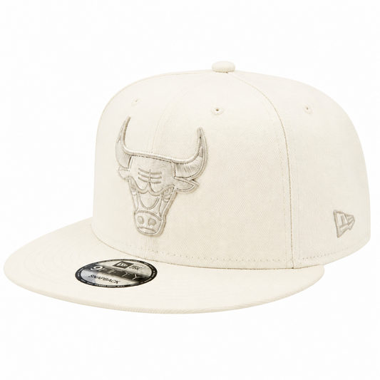 An off-white New Era 9FIFTY fitted cap featuring an embroidered Chicago Bulls logo on the front and a small New Era flag logo on the side, set against a plain white background.