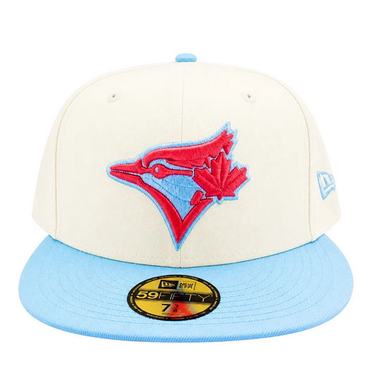 A Toronto Blue Jays 59FIFTY fitted baseball cap by New Era, featuring an off-white crown with a red and light blue embroidered team logo, and a light blue flat brim with a gold size sticker.