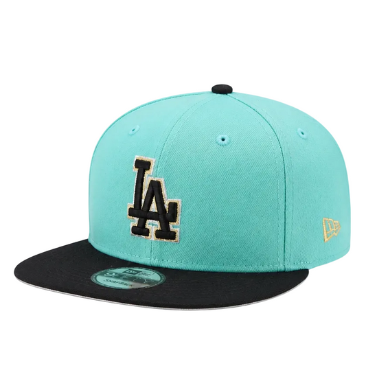 A Los Angeles Dodgers New Era 59FIFTY fitted cap featuring a mint green crown, a black flat brim, and a black embroidered 'LA' logo outlined in gold on the front.