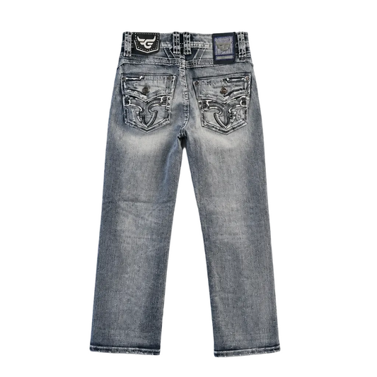 Back view of light-wash blue denim jeans with ornate silver and black embroidered patches on the back pockets, photographed flat on a light gray background.