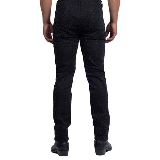 Person wearing black textured pants on a white background