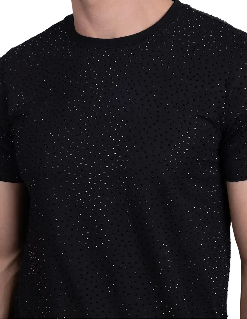Black t-shirt with subtle pattern worn by a person on a light gray background